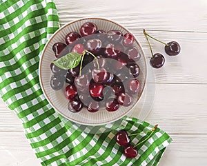 cherry raw in a plate summer organic natural delicious ripe on a white wooden