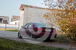 Cherry red 4 door family d-class sedan Toyota Camry