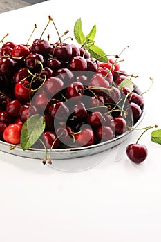 Cherry. Red fresh Cherries in bowl and a bunch of cherries on th