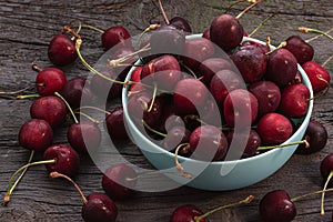 Cherry . Ripe red cherries in ceramic bowl on wooden table