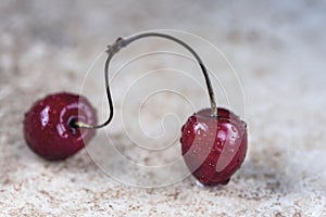 Cherry stalk with motion on a wooden background, close up