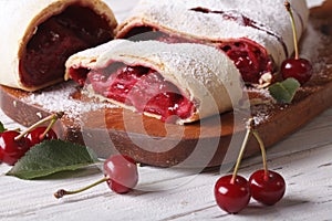 Cherry strudel on a wooden board close up. horizontal