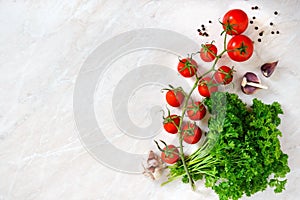 Cherry tomato branch, garlic, fresh parsley, pepper on a light background