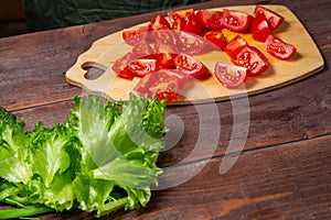 Cherry tomato cut in half on a wooden board