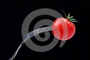 Cherry tomato with a fork
