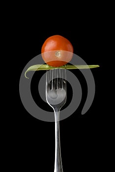 Cherry tomato and peas on fork