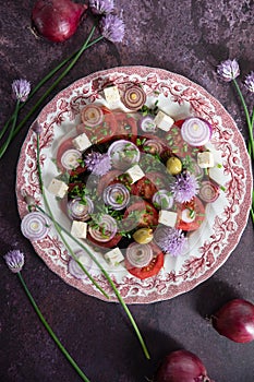 cherry tomato salad with purple onion, feta chees and balsamic vinegar, flat lay