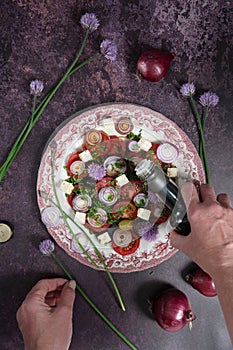 cherry tomato salad with purple onion, feta chees and balsamic vinegar, flat lay