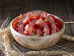 Cherry tomato sliced in wooden bowl