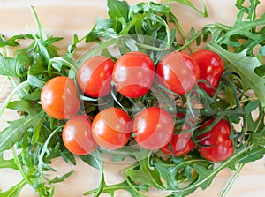 Cherry tomatoes on a background of salad leaves