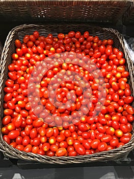 Cherry tomatoes on basket in supermarket.