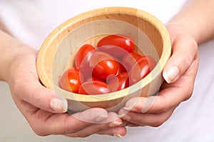 Cherry tomatoes into a bowl