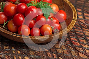 Cherry tomatoes in bowl on rustic table