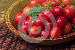 Cherry tomatoes in bowl on rustic table