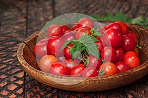 Cherry tomatoes in bowl on rustic table