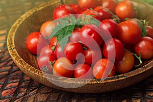 Cherry tomatoes in bowl on rustic table