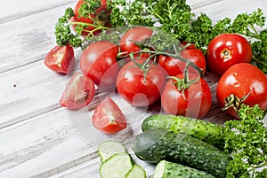 Cherry tomatoes on a branch, cucumber, parsley