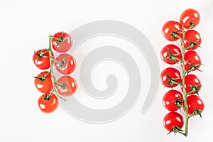 Cherry tomatoes on branch isolated on white background. Top view