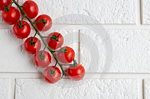 Cherry tomatoes on a branch, isolated on a white background. The view from the top. the concept of crop