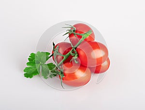 Cherry tomatoes on a branch with a parsley leaf isolated on a white background