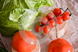 Cherry tomatoes, cabbage on a deervian background. preparation of salad. Summer concept of proper healthy eating.