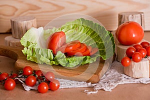 Cherry tomatoes, cabbage on a deervian background. preparation of salad. Summer concept of proper healthy eating.