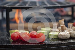 Cherry tomatoes, champignon mushrooms, zucchini cooked on a hot grill surface
