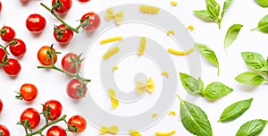 Cherry tomatoes with different types of pasta and basil leaves on white. Italian food concept