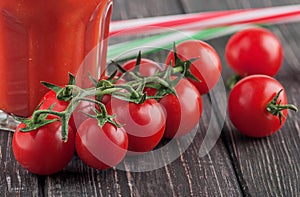 Cherry tomatoes and glass of tomato photo