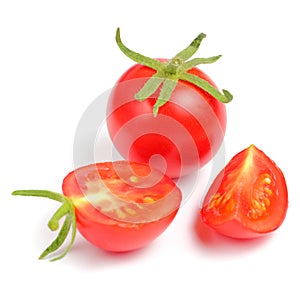 Cherry tomatoes with greens branches on a white background close-up, place for text, isolate