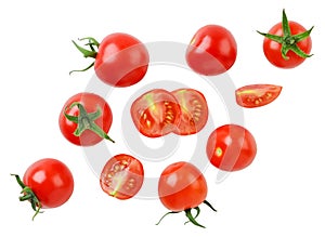 Cherry tomatoes and halves are flying on a white background. Isolated