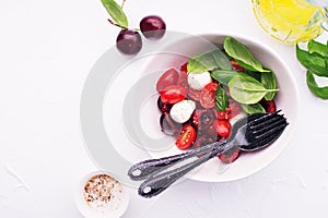 Cherry tomatoes mozzarella classic salad appetizer with the addition of fruits, basil. The new version of the salad