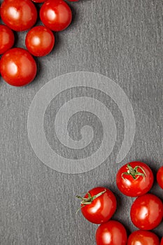 Cherry tomatoes over stone table.