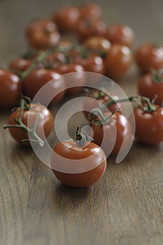 Cherry tomatoes over wooden background