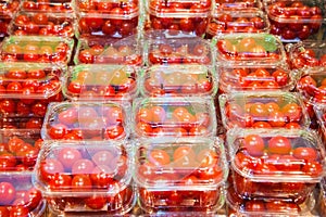 Cherry tomatoes packed in plastic containers