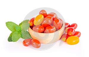 Cherry tomatoes and pepermint in wood bowl isolated on white background, food healhty concept