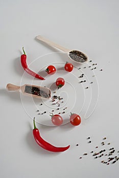 Cherry Tomatoes, red hot chili Pepper, fragrant black pepper peas on a White Background