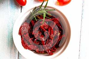 Cherry tomatoes with rosemary greens and  on the white wooden background table