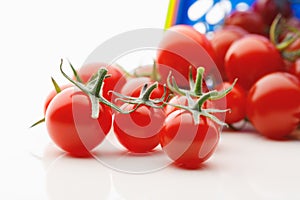 Cherry tomatoes scattered on white background