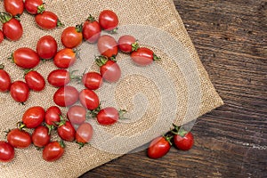Cherry tomatoes ,is a small tomatos on wood top ,have beta-carotene vitamin C and vitamin E