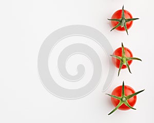 Cherry tomatoes on white background with copy-space