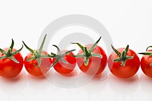 Cherry tomatoes on white background with copy-space