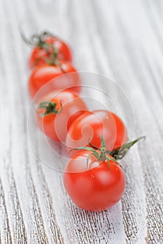 Cherry tomatoes on white painted wood table
