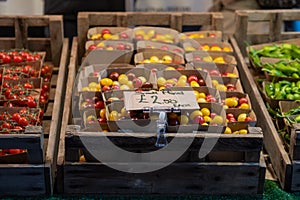 Cherry tomatoes in a wooden crate on sale