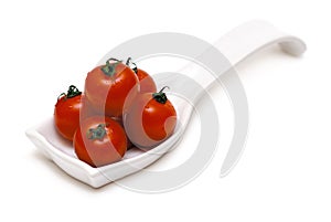 Cherry tonatoes in a white spoon