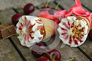 Cherry vanilla ice-cream with caramel topping. Closeup