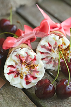 Cherry vanilla ice-cream with caramel topping. Closeup