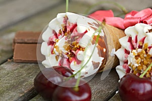 Cherry vanilla ice-cream with caramel topping. Closeup