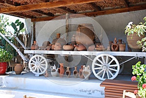 Chersonissos, Cyprus, Greece - 31.07.2013: clay pots and dishes on a wooden cart