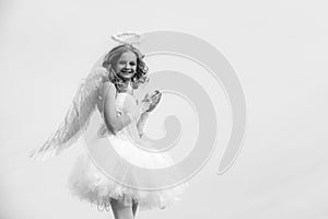 Cherub angel pray. The God of Love. Portrait of little curly blond Angel girl. Love card. Angel child girl with curly